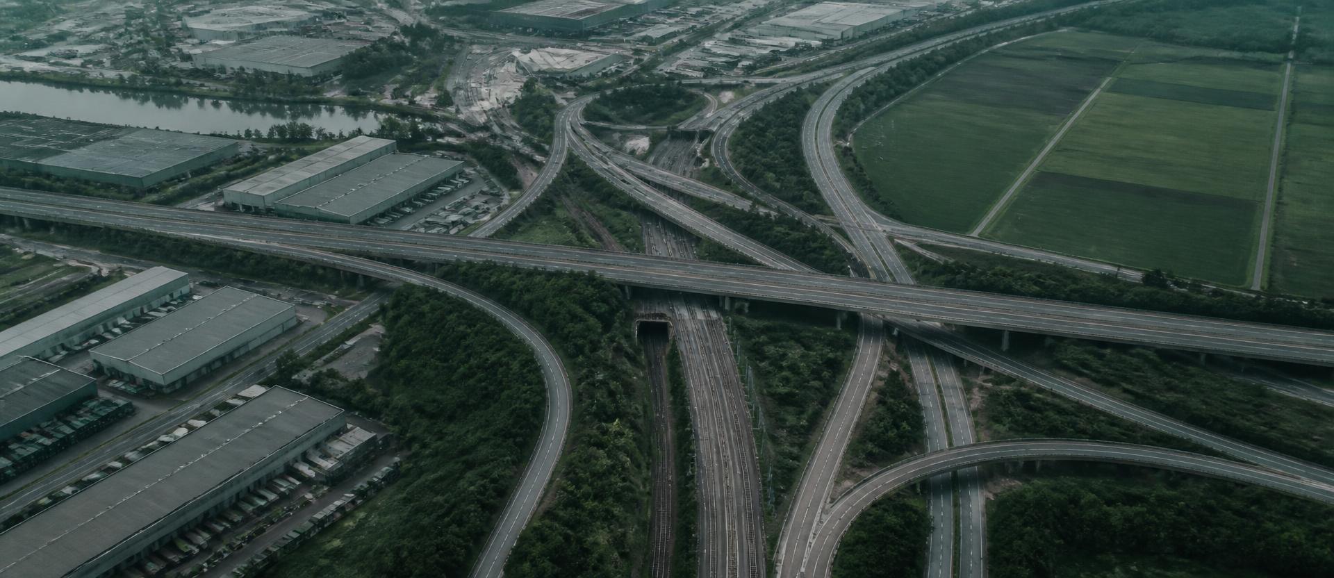 Aerial view of a highway, rail and industrial logistics junction